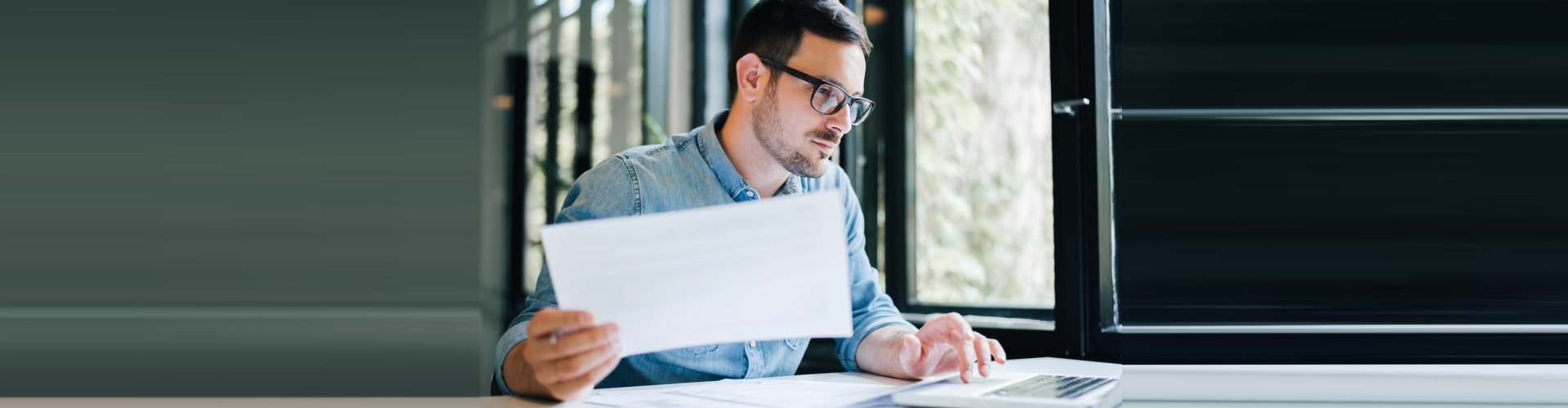 a man holding a paper