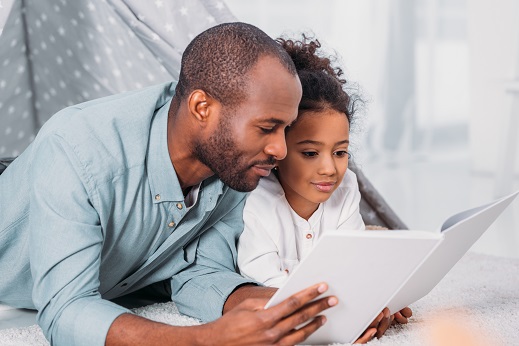 father and daughter reading book