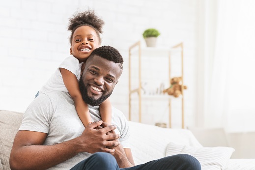 father and daughter smiling